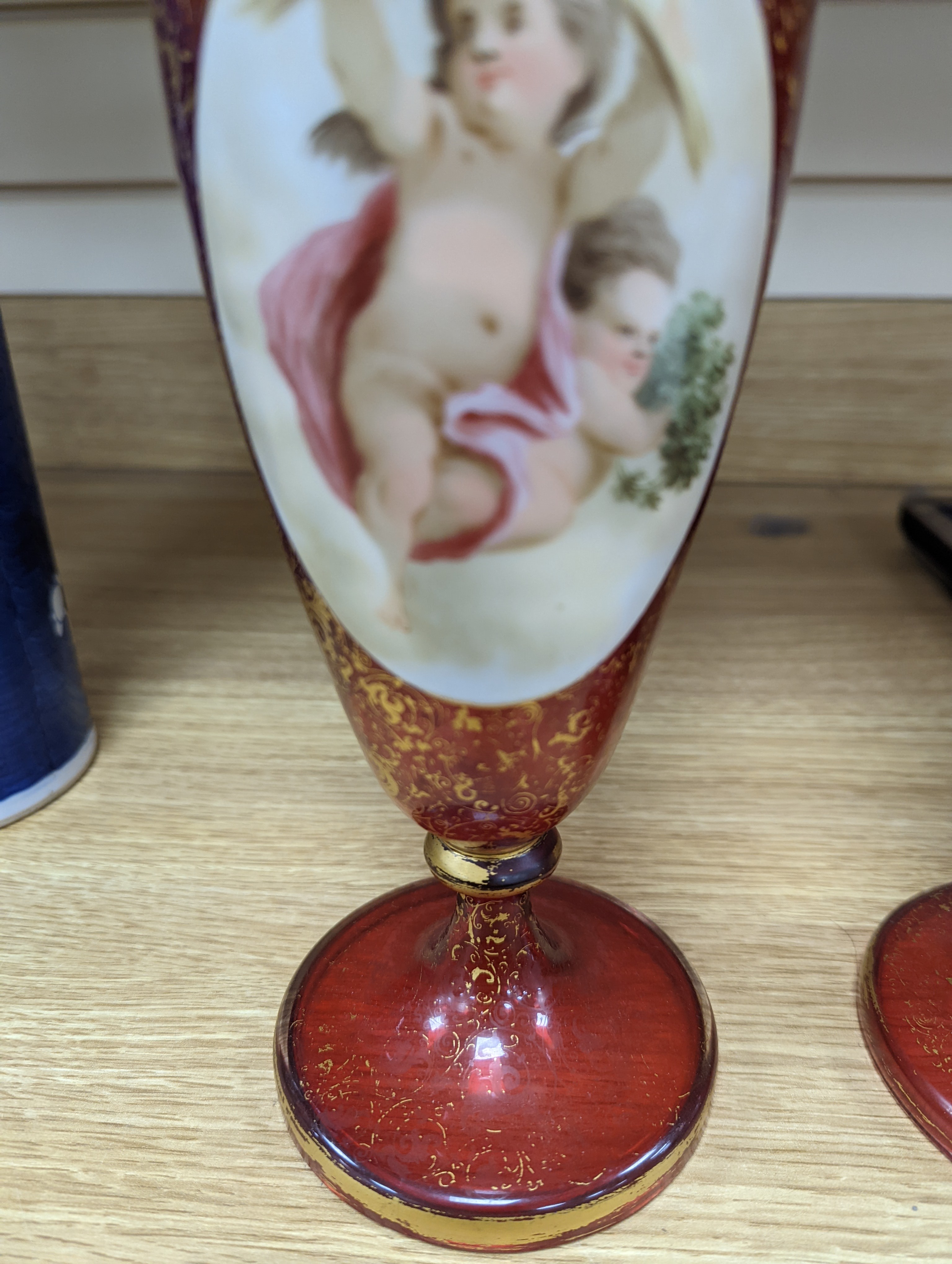 A pair of 19th century Bohemian enamelled and overlaid ruby glass vases 36cm